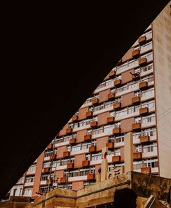 Low angle view of buildings against sky at night