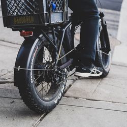 Low section of man with bicycle on street