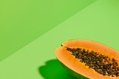 Close-up of orange fruit against white background