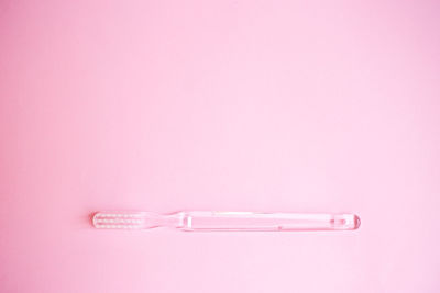 High angle view of umbrella against pink background