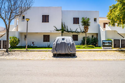 Rear view of white building against blue sky