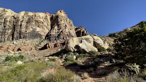 Rock formations on mountain against clear sky