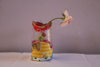 Close-up of yellow rose on glass table