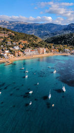 High angle view of townscape by sea against sky