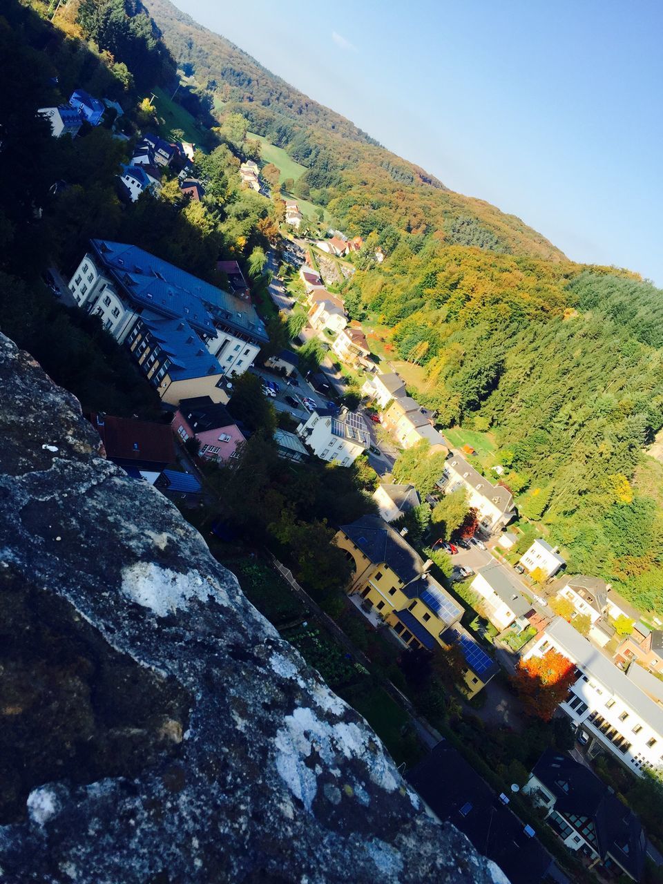 mountain, building exterior, tree, built structure, architecture, high angle view, transportation, house, clear sky, day, water, nature, mode of transport, sky, outdoors, landscape, no people, scenics, sunlight, residential structure