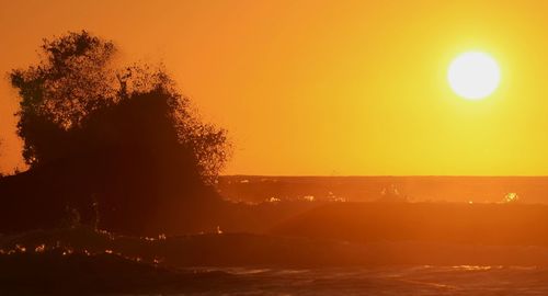 Scenic view of sea against orange sky