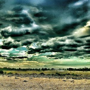 Scenic view of landscape against cloudy sky