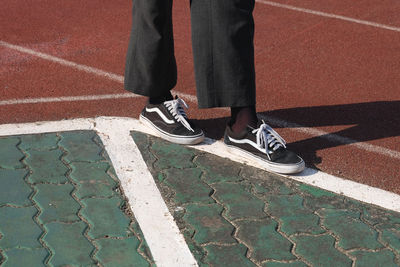 Low section of man standing on footpath