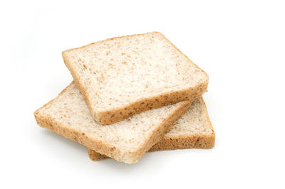 High angle view of bread on plate against white background