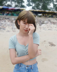 Girl looking away while standing on land