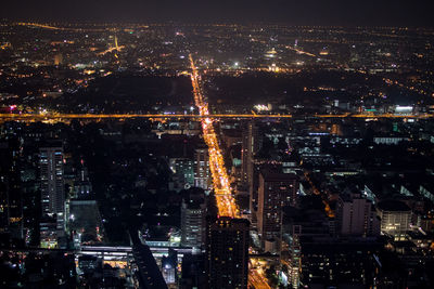 High angle view of illuminated buildings in city at night