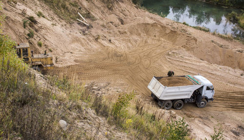  may 2019 mining machinery performing operations. excavator working digging in sand quarry