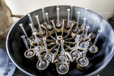 High angle view of glass flasks in containers at dairy farm