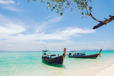 Boats in sea against sky