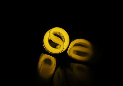 Close-up of yellow light over black background