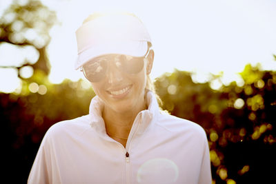 A backlit portrait of an athletic woman.