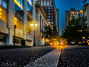 Close-up of illuminated city street at night