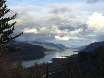 Scenic view of lake against cloudy sky