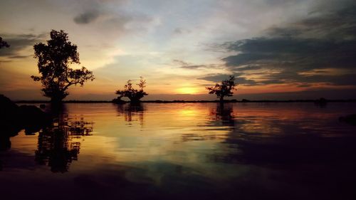 Scenic view of lake against sky during sunset