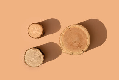 Three wooden disks on trendy beige background. platform for natural cosmetics presentation