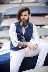 Handsome hipster sitting outdoors