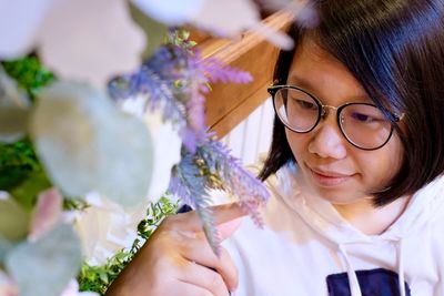 Close-up of girl looking at decoration