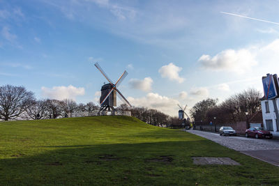 Windmill on field against sky