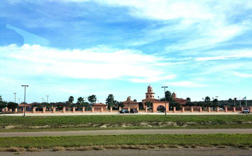 View of town square against cloudy sky