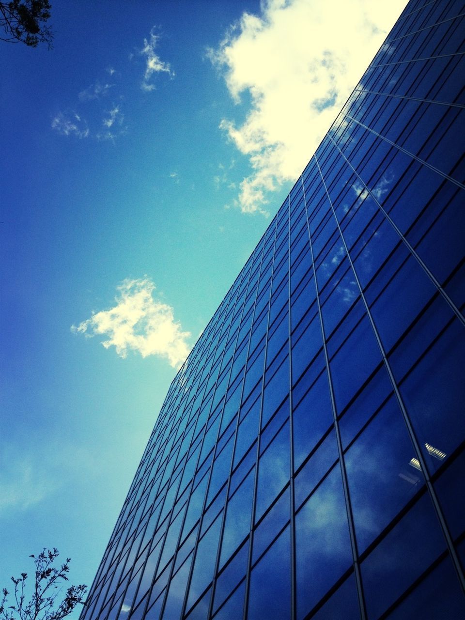 architecture, building exterior, built structure, low angle view, modern, office building, reflection, sky, skyscraper, glass - material, city, tall - high, blue, tower, building, cloud - sky, cloud, day, glass, window