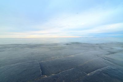 Scenic view of water against sky during sunset