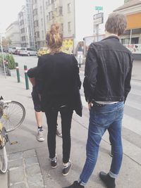 Rear view of woman standing on city street