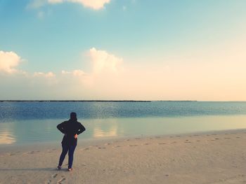 Rear view of man walking on beach