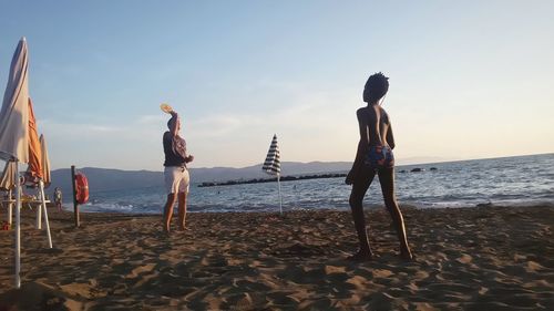 People on beach against sky