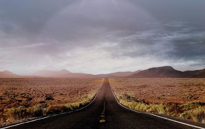 Road amidst landscape against sky