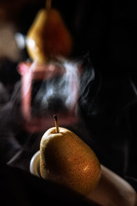 Cropped hand holding apple on table