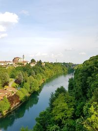 High angle view of river amidst trees against sky