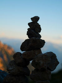 Close-up of stack of rocks against sky