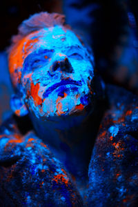 Close-up of blue paint on rock at night