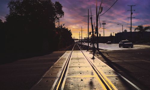 Cars on road at sunset