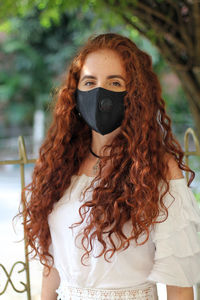 Portrait of a young woman wearing covid mask