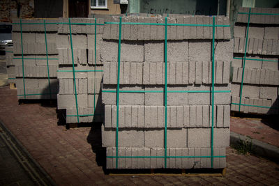 Stack of chairs on footpath by street