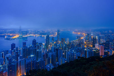 High angle view of city lit up at night