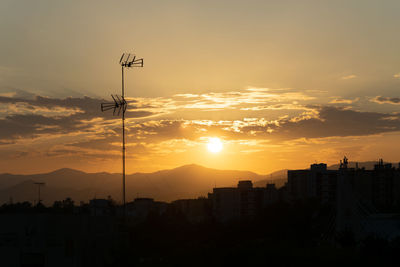 A beautiful golden sunset with the sun just about to go behind the mountain silhouettes in andalucía