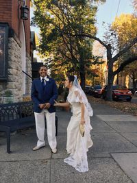 Full length of couple standing on footpath