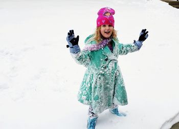 Portrait of girl standing on snow