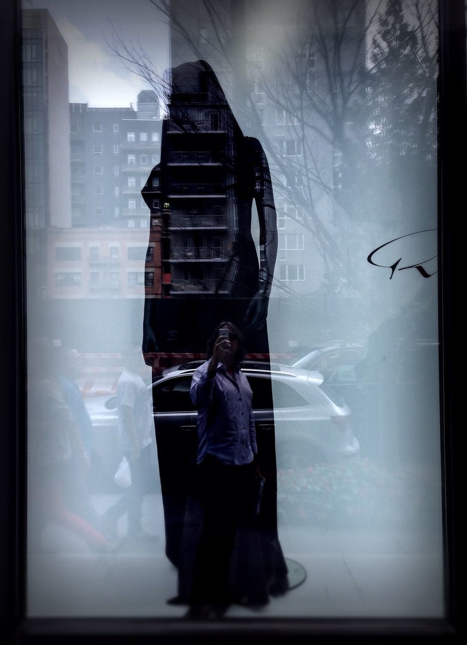 indoors, lifestyles, rear view, men, full length, glass - material, transparent, window, standing, leisure activity, transfer print, person, auto post production filter, casual clothing, looking through window, three quarter length, built structure, architecture