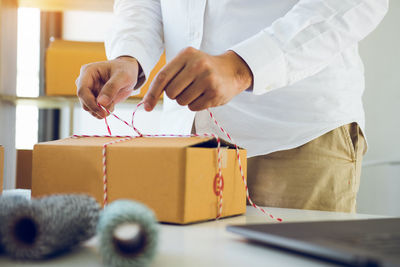 Midsection of man working on table