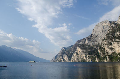 Scenic view of sea and mountains against sky