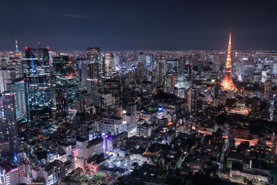 Illuminated cityscape against sky at night