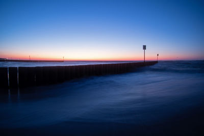 Scenic view of sea against clear sky during sunset